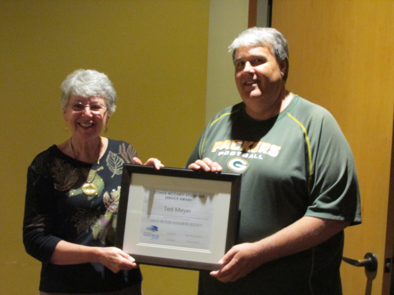 Ted Meyer accepting award from Donna McCarty