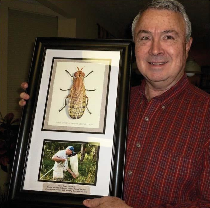 Bill Murphy holding award plaque